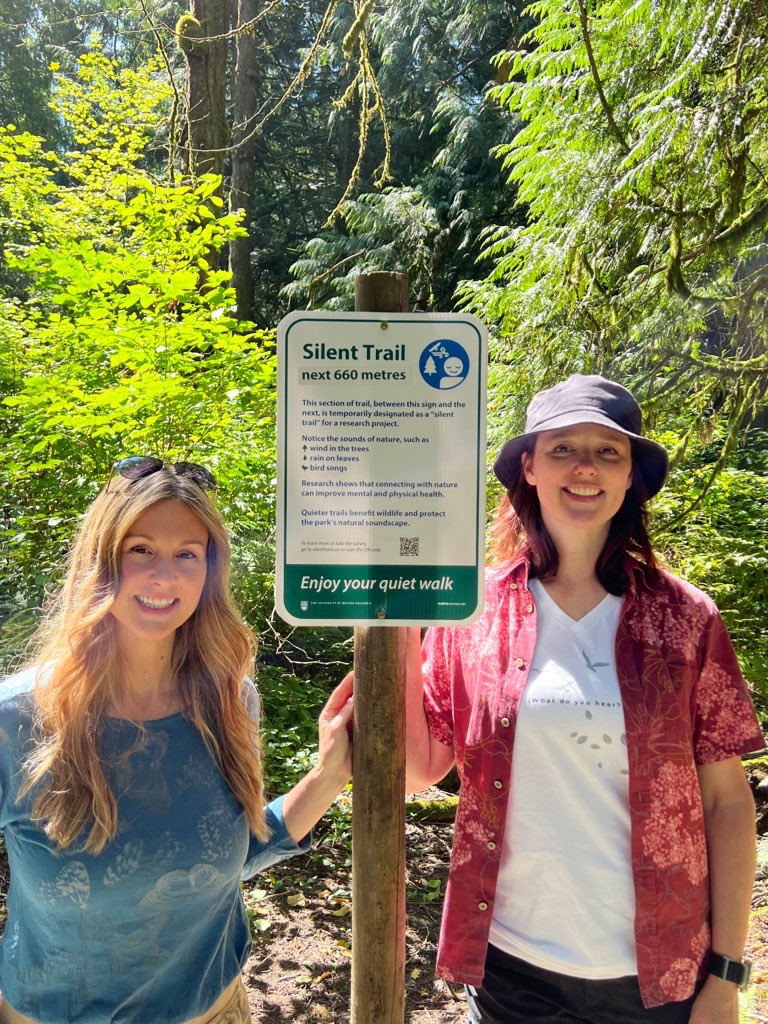 Kristine Koster and Dr. Tara Tiger Brown standing next to a Silent Trail sign